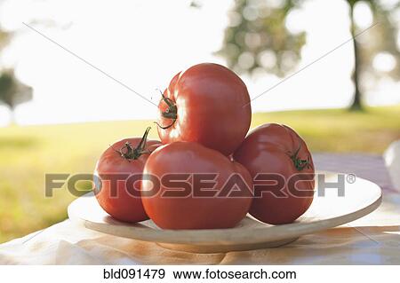 Close up of tomatoes on plate View Large Photo Image Stock Photo - Close up of tomatoes on plate. Fotosearch