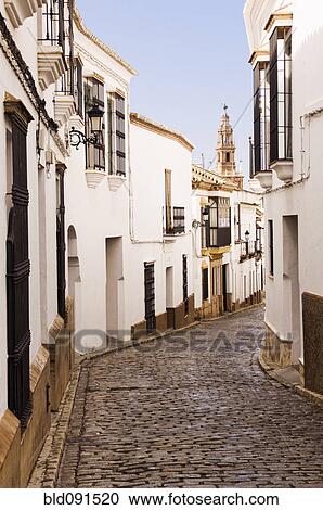 Stock Image - Cobblestone alley of quaint village. Fotosearch