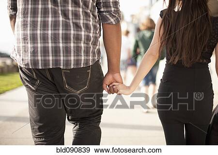 Stock Photo - Couple holding hands outdoors. Fotosearch