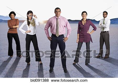 Diverse business people standing together in desert View Large Photo Image Stock Photo - Diverse business people standing together in desert. Fotosearch