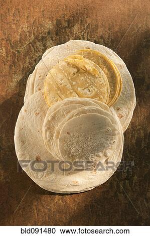 Stock Image - Flour and corn tortillas on table. Fotosearch
