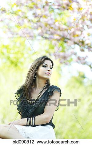 Glamorous Caucasian woman sitting outdoors View Large Photo Image Stock Image - Glamorous Caucasian woman sitting outdoors. Fotosearch