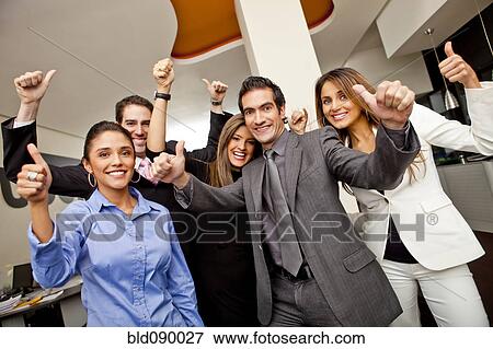 Stock Photo - Hispanic business people giving the thumbs up. Fotosearch