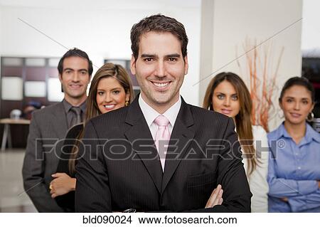 Picture - Hispanic business people standing together in office. Fotosearch