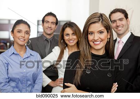Stock Photography - Hispanic business people standing together in office. Fotosearch