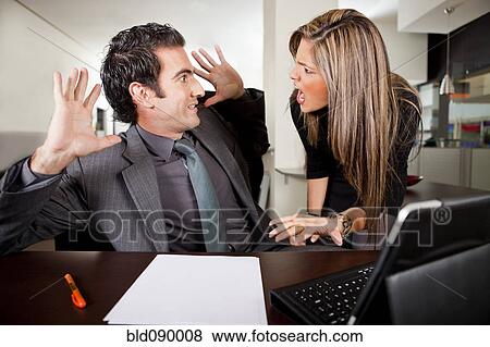 Stock Photo - Hispanic businesswoman shouting at co-worker in office. Fotosearch