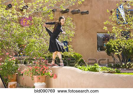 Stock Photo - Hispanic woman dancing on wall. Fotosearch