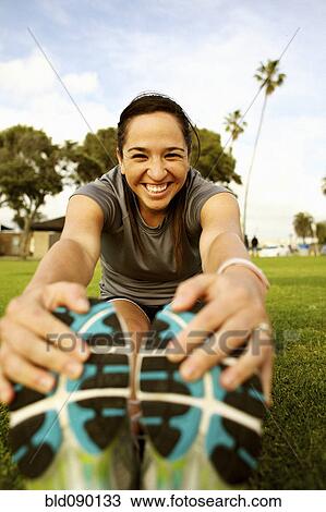 Hispanic woman stretching in park before exercising View Large Photo Image Stock Image - Hispanic woman stretching in park before exercising. Fotosearch