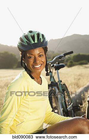 Mixed race biker taking break in remote area View Large Photo Image Stock Image - Mixed race biker taking break in remote area. Fotosearch