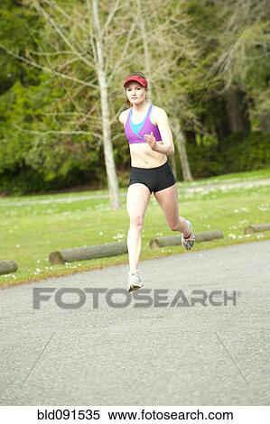 Stock Photography - Mixed race teenager running outdoors. Fotosearch
