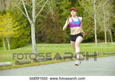 Stock Photography - Mixed race teenager running outdoors. Fotosearch