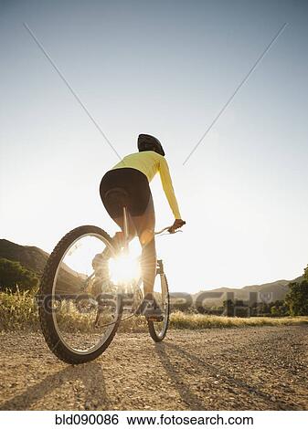 Mixed race woman riding on mountain bike View Large Photo Image Stock Photograph - Mixed race woman riding on mountain bike. Fotosearch