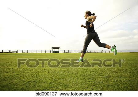 Mixed race woman running in park field View Large Photo Image Stock Photo - Mixed race woman running in park field. Fotosearch