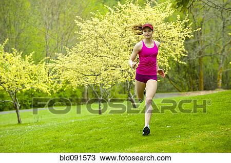Mixed race woman running in park View Large Photo Image Stock Image - Mixed race woman running in park. Fotosearch