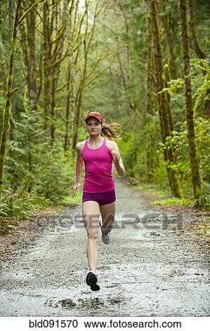 Mixed race woman running on remote path View Large Photo Image Stock Image - Mixed race woman running on remote path. Fotosearch