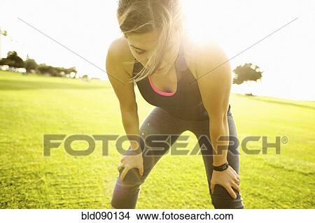 Mixed race woman standing in field after exercise View Large Photo Image Picture - Mixed race woman standing in field after exercise. Fotosearch