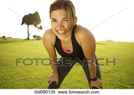Mixed race woman standing in field after exercise View Large Photo Image Stock Photography - Mixed race woman standing in field after exercise. Fotosearch