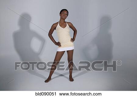 Mixed race woman standing with hands on hips View Large Photo Image Stock Image - Mixed race woman standing with hands on hips. Fotosearch