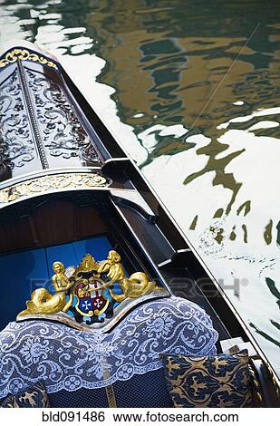 Stock Photograph - Ornate gondola in canal. Fotosearch