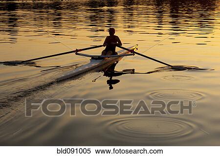 Stock Photography - Person rowing sculling boat on river. Fotosearch