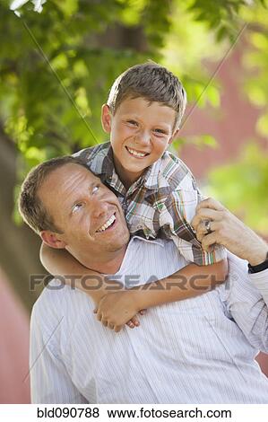 Stock Photo - Playful Caucasian father and son. Fotosearch