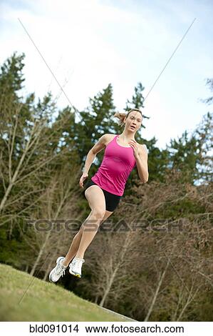 Picture - Serious Caucasian woman running. Fotosearch