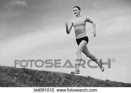 Stock Image - Serious Caucasian woman running. Fotosearch