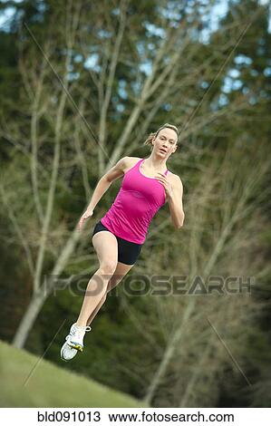 Stock Image - Serious Caucasian woman running. Fotosearch