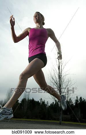 Stock Photo - Serious Caucasian woman running. Fotosearch