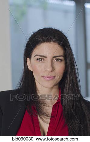 Stock Image - Serious Hispanic businesswoman. Fotosearch