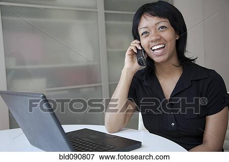 Smiling businesswoman talking on cell phone View Large Photo Image Stock Photo - Smiling businesswoman talking on cell phone. Fotosearch