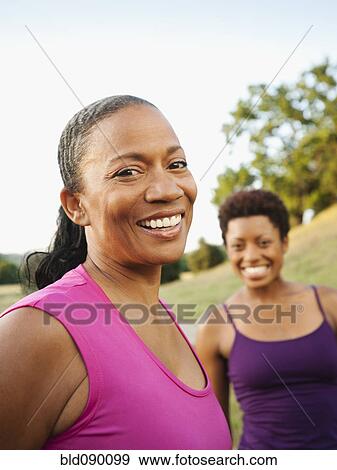 Smiling friends standing together outdoors View Large Photo Image Stock Photo - Smiling friends standing together outdoors. Fotosearch