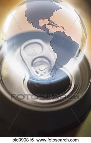 Stock Photograph - Transparent globe hovering over aluminum can. Fotosearch