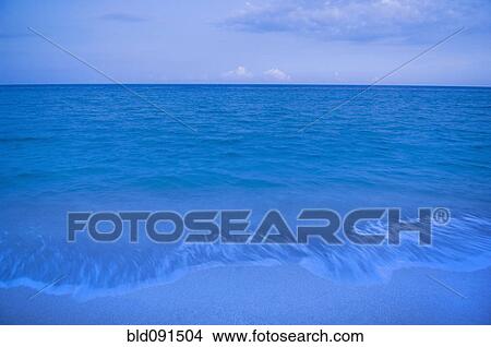 Picture - Waves on beach of tranquil blue ocean. Fotosearch