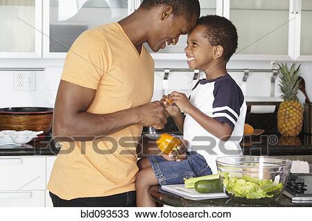 African American father and son making salad in kitchen View Large Photo Image Stock Image - African American father and son making salad in kitchen. Fotosearch