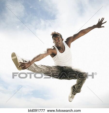 African American man jumping in mid-air View Large Photo Image Stock Photo - African American man jumping in mid-air. Fotosearch