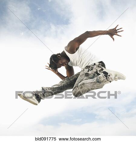 African American man jumping in mid-air View Large Photo Image Stock Photography - African American man jumping in mid-air. Fotosearch