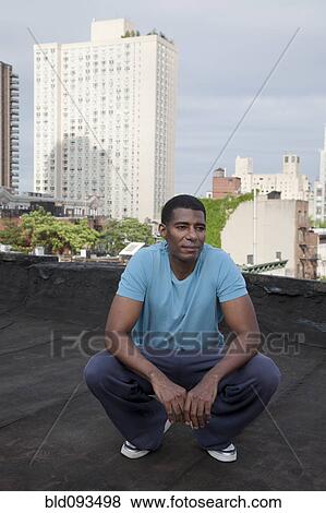 African American man standing on rooftop View Large Photo Image Stock Photo - African American man standing on rooftop. Fotosearch