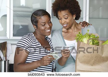 African American mother and daughter reviewing grocery bill View Large Photo Image Stock Image - African American mother and daughter reviewing grocery bill. Fotosearch