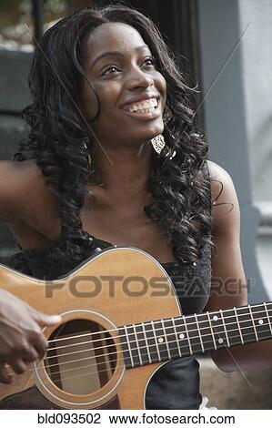African American woman strumming guitar View Large Photo Image Stock Image - African American woman strumming guitar. Fotosearch