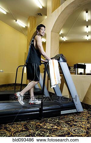 Asian man exercising in health club View Large Photo Image Stock Photograph - Asian man exercising in health club. Fotosearch