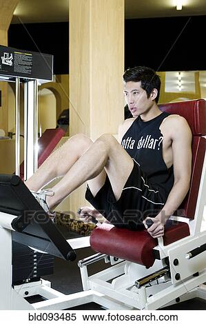 Stock Photography - Asian man exercising in health club. Fotosearch