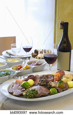 Stock Photo - Beef and vegetables dinner with wine. Fotosearch