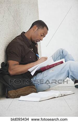 Black college student doing homework outdoor View Large Photo Image Picture - Black college student doing homework outdoor. Fotosearch