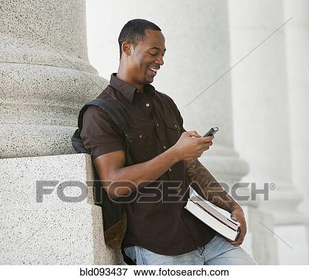 Black college student text messaging on cell phone View Large Photo Image Stock Photo - Black college student text messaging on cell phone. Fotosearch