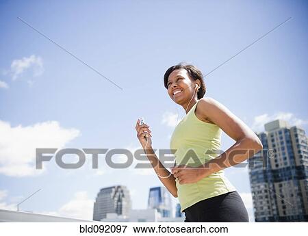 Black woman exercising and listening to mp3 player View Large Photo Image Stock Photo - Black woman exercising and listening to mp3 player. Fotosearch