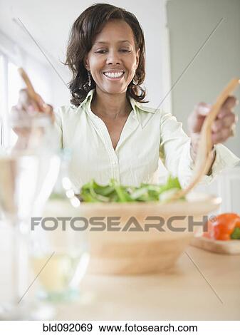 Stock Photo - Black woman tossing salad. Fotosearch