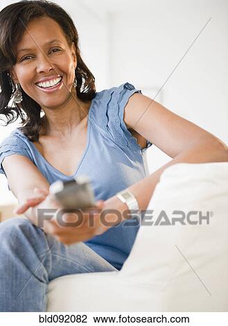 Black woman watching tv View Large Photo Image Stock Image - Black woman watching tv. Fotosearch