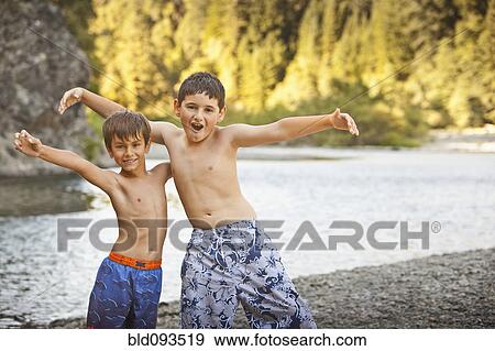 Stock Photo - Boys playing near remote stream. Fotosearch