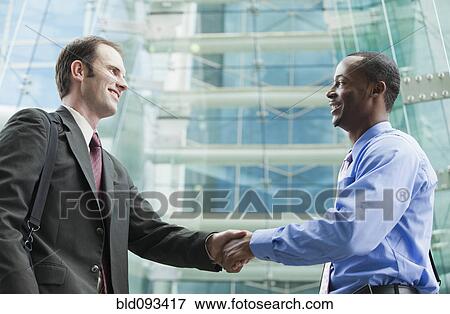 Stock Photo - Businessman shaking hands. Fotosearch